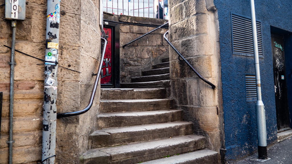 Steps onto Calton Road in Edinburgh which is a Trainspotting film location