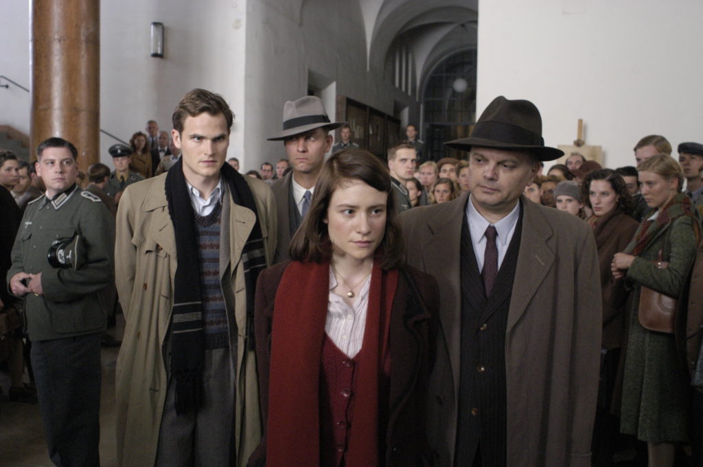 Film still from Sophie Scholl: The Final Days (2005) of two prisoners outside a courtroom