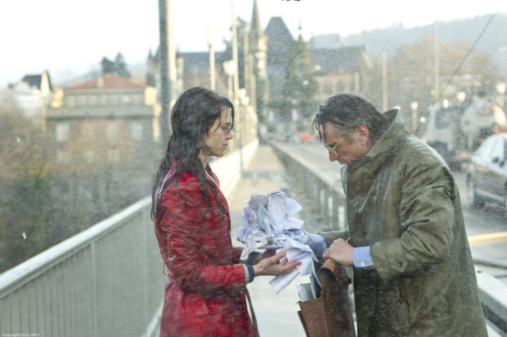 Still of a man and woman soaking wet from the film Night Train to Lisbon (2013)