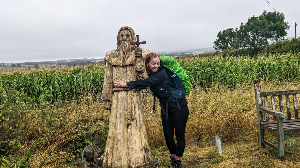 Almost Ginger blog owner hugging wooden St Cuthbert statue