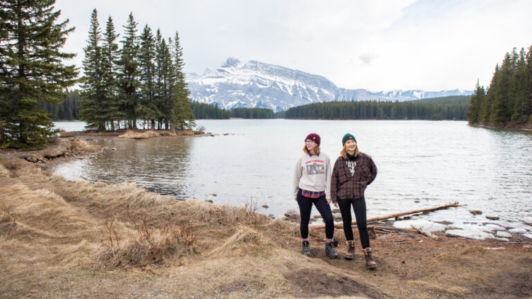 Two women at Two Jack Lake in Banff National Park, Canada on a Vancouver to Calgary Road Trip