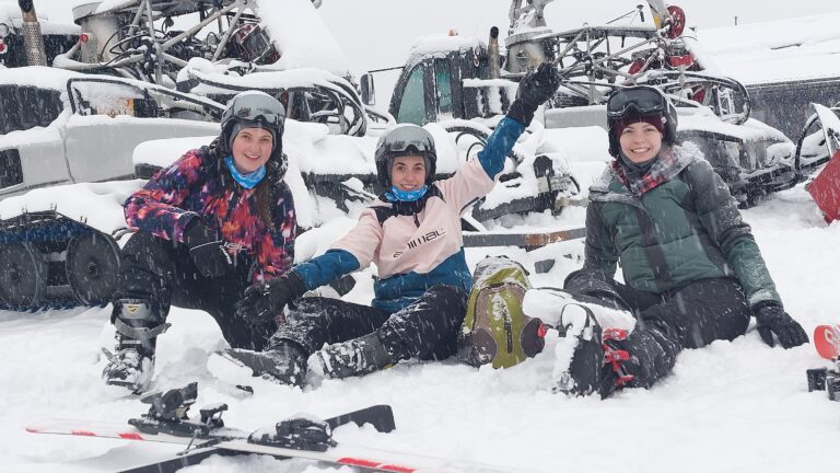 Almost Ginger blog owner with two friends in ski gear sat in the snow at La Fouly Ski Resort, Switzerland