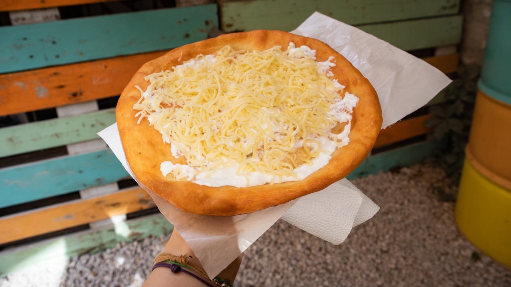 Langos flatbread with sour cream and cheese at Karavan Street Food Market in Budapest, Hungary