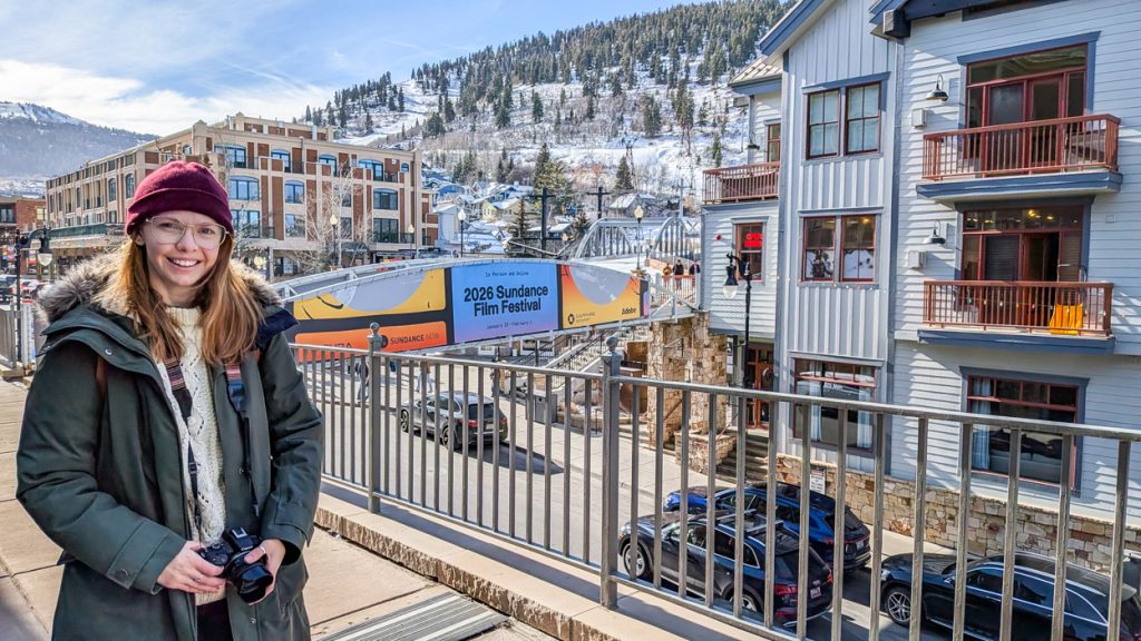 Offscreen Tourist owner with a 2026 Sundance Film Festival sign on Main Street in Park City, Utah